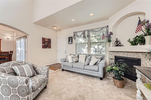 15501 E 112th Ave Unit 28E, Commerce City, CO 80022 - carpeted living room with arched walkways, recessed lighting, and a glass covered fireplace