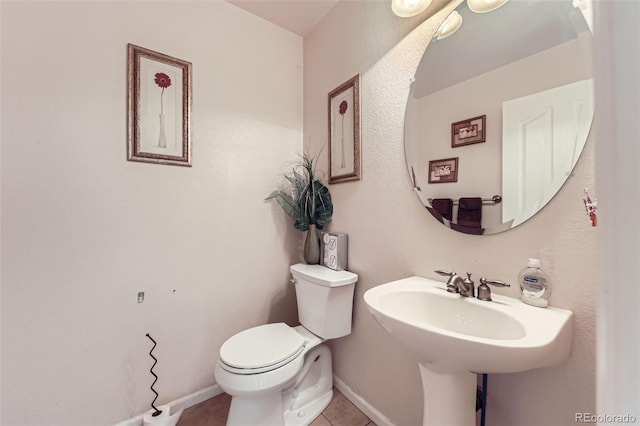 15501 E 112th Ave Unit 28E, Commerce City, CO 80022 - half bathroom with toilet, tile patterned floors, and baseboards