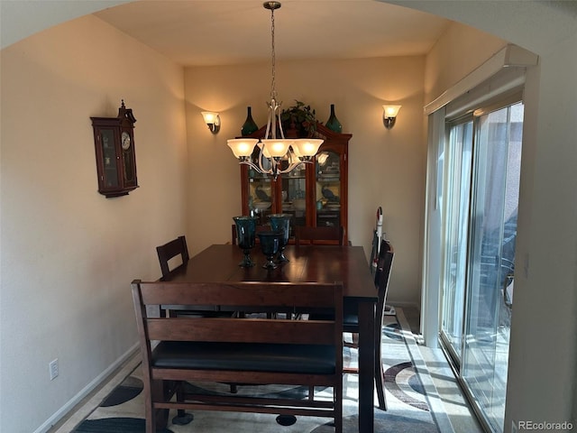 15501 E 112th Ave Unit 28E, Commerce City, CO 80022 - dining area featuring a chandelier, arched walkways, and baseboards
