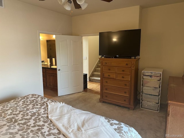 15501 E 112th Ave Unit 28E, Commerce City, CO 80022 - bedroom with light colored carpet, connected bathroom, and a ceiling fan