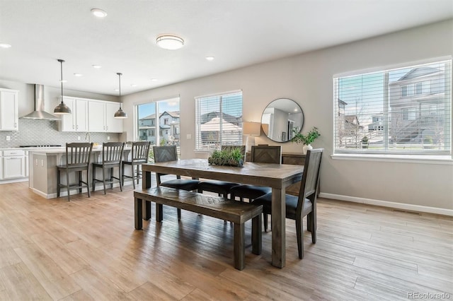 dining room with recessed lighting, light wood finished floors, baseboards, and visible vents