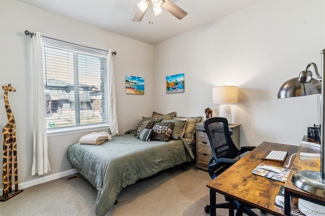 bedroom featuring baseboards, a ceiling fan, carpet, and multiple windows