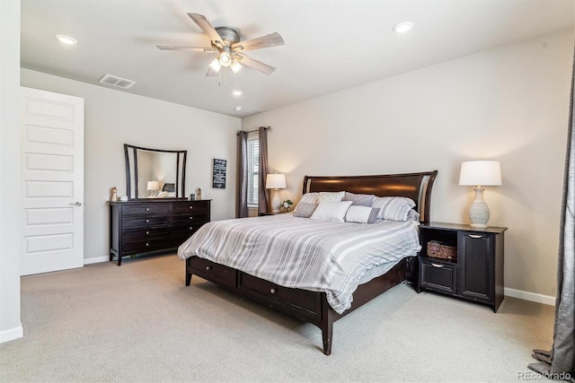 bedroom with baseboards, light colored carpet, and visible vents