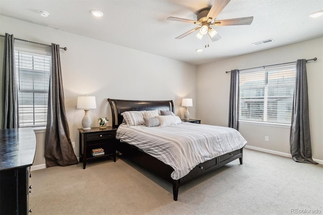 bedroom with visible vents, baseboards, ceiling fan, and light colored carpet