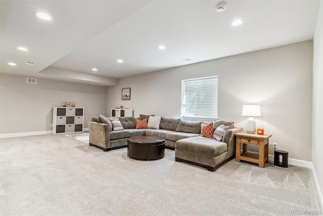 living area featuring recessed lighting, baseboards, visible vents, and light carpet