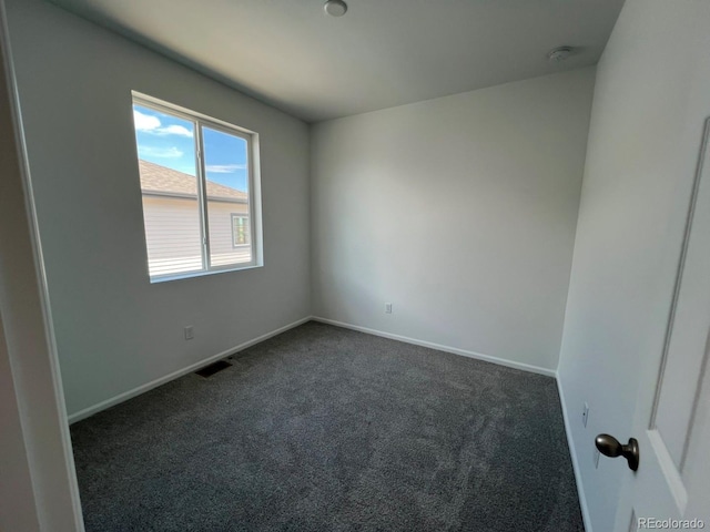 6599 N Netherland St, Aurora, CO 80019 - spare room featuring dark carpet and baseboards
