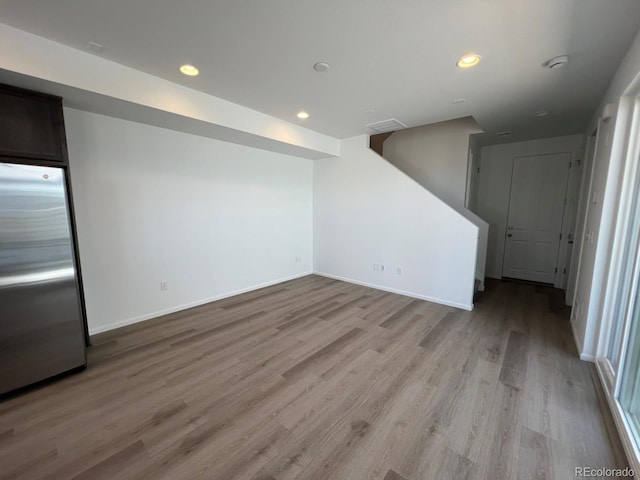 6599 N Netherland St, Aurora, CO 80019 - unfurnished living room with light wood-style floors and recessed lighting
