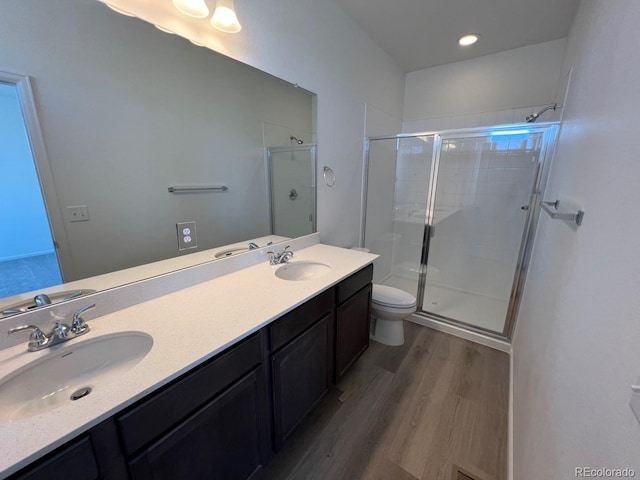 6599 N Netherland St, Aurora, CO 80019 - full bath with wood finished floors, a stall shower, and double vanity