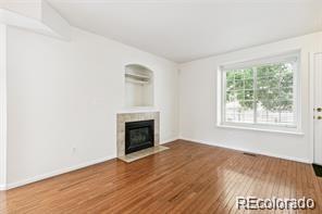 unfurnished living room with wood-type flooring and a fireplace