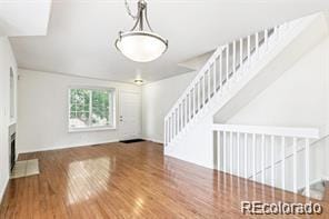 unfurnished living room featuring wood-type flooring