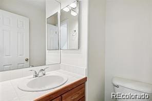 bathroom with vanity and toilet