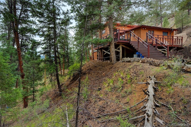 exterior space with stairway and a wooden deck