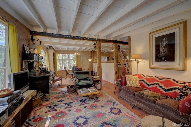 living room featuring wood walls, light hardwood / wood-style floors, and beamed ceiling