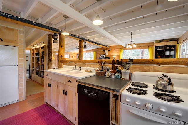 kitchen with white appliances, wood walls, light brown cabinetry, hanging light fixtures, and lofted ceiling with beams