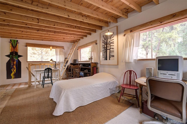 bedroom with beamed ceiling and carpet floors