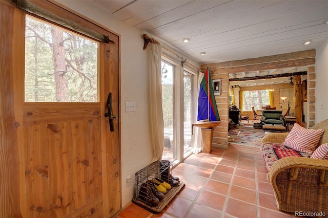 interior space featuring tile patterned flooring and wood ceiling