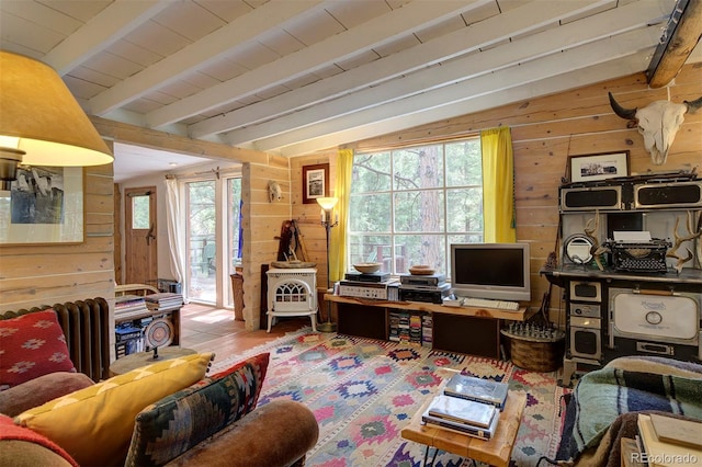 office area featuring vaulted ceiling with beams, radiator, and wood walls