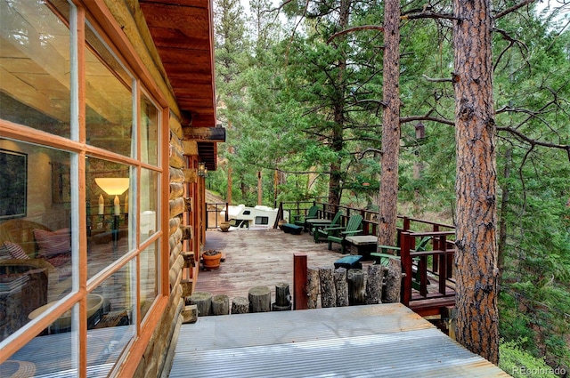 wooden deck with a sunroom