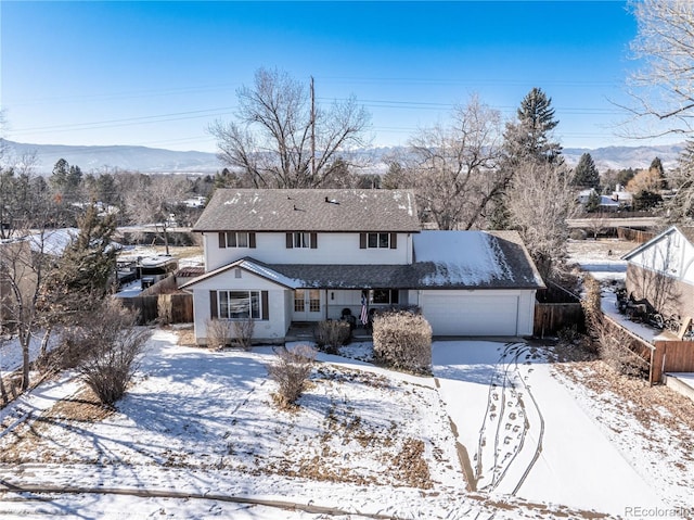 traditional-style home featuring a shingled roof, fence, french doors, a garage, and driveway