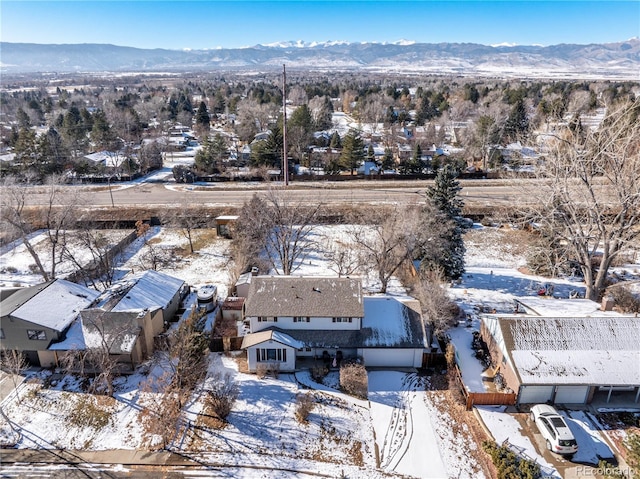 snowy aerial view with a mountain view