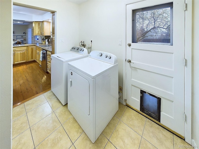 washroom featuring washing machine and dryer and light tile patterned floors