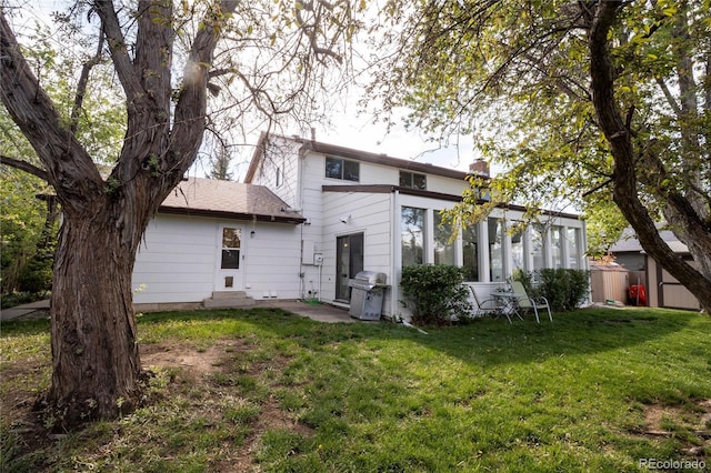 rear view of property featuring a chimney and entry steps