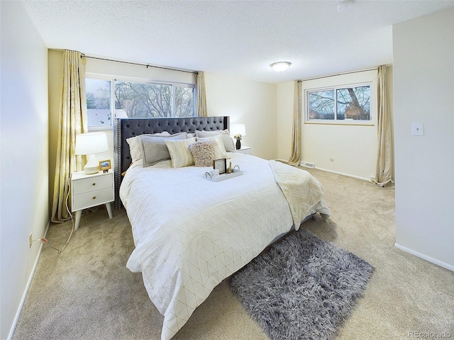 carpeted bedroom with baseboards and a textured ceiling