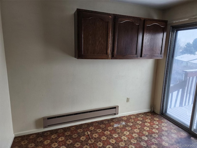 laundry room featuring a baseboard radiator and plenty of natural light