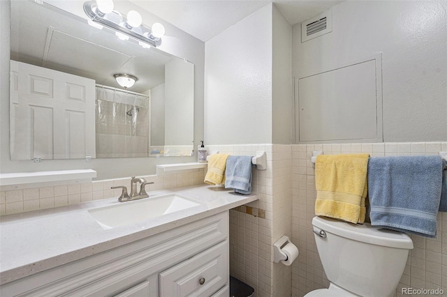 1020 15th St Unit 12C, Denver, CO 80202 - full bathroom with tile walls, vanity, a wainscoted wall, and a shower with curtain