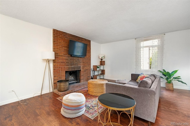 3341 S Monaco Pkwy Unit A, Denver, CO 80222 - living room with wood finished floors, baseboards, a textured ceiling, and a brick fireplace