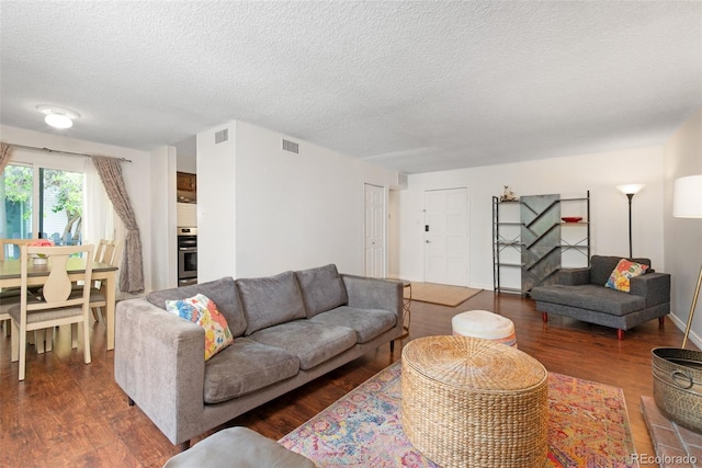 3341 S Monaco Pkwy Unit A, Denver, CO 80222 - living area featuring wood finished floors and a textured ceiling