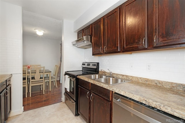 3341 S Monaco Pkwy Unit A, Denver, CO 80222 - kitchen featuring wall chimney range hood, appliances with stainless steel finishes, a sink, decorative backsplash, and a textured ceiling