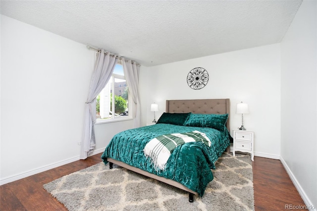 3341 S Monaco Pkwy Unit A, Denver, CO 80222 - bedroom featuring wood finished floors, baseboards, and a textured ceiling