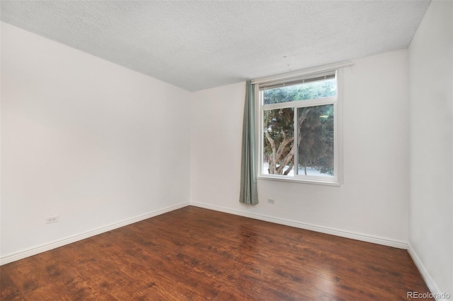 3341 S Monaco Pkwy Unit A, Denver, CO 80222 - spare room with wood finished floors, baseboards, and a textured ceiling