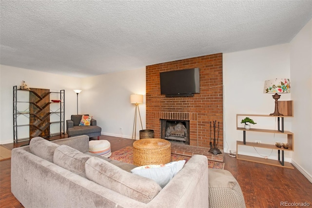 3341 S Monaco Pkwy Unit A, Denver, CO 80222 - living area featuring wood finished floors, a fireplace, baseboards, and a textured ceiling