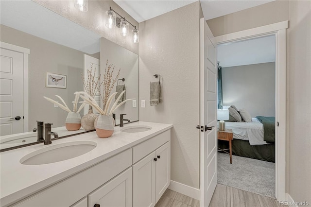 6366 N Emporia St, Denver, CO 80238 - ensuite bathroom featuring double vanity and wood finished floors
