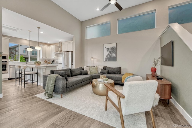 6366 N Emporia St, Denver, CO 80238 - living area with ceiling fan, light wood finished floors, healthy amount of natural light, recessed lighting, and a high ceiling
