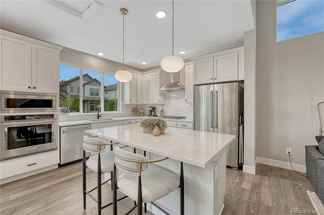 6366 N Emporia St, Denver, CO 80238 - kitchen with appliances with stainless steel finishes, light wood-style flooring, decorative backsplash, white cabinets, and recessed lighting