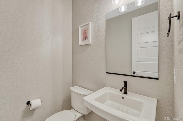6366 N Emporia St, Denver, CO 80238 - half bath with a sink and a textured wall