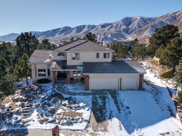 2770 Rossmere St, Colorado Springs, CO 80919 - traditional-style home featuring a garage, a tile roof, driveway, and brick siding
