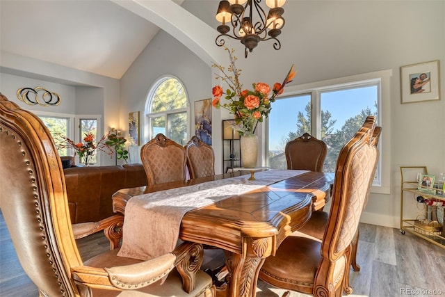 2770 Rossmere St, Colorado Springs, CO 80919 - dining room with high vaulted ceiling, arched walkways, a chandelier, and wood finished floors