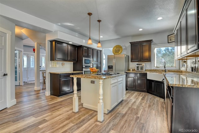 2770 Rossmere St, Colorado Springs, CO 80919 - kitchen with appliances with stainless steel finishes, light wood-type flooring, dark brown cabinets, recessed lighting, and plenty of natural light