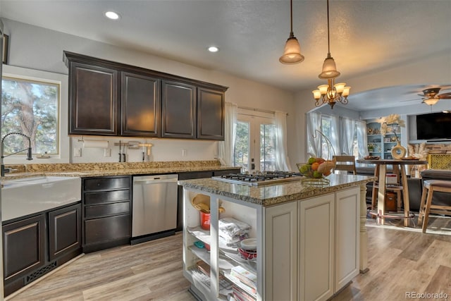 2770 Rossmere St, Colorado Springs, CO 80919 - kitchen featuring appliances with stainless steel finishes, light stone countertops, a chandelier, ceiling fan, and light wood-style flooring