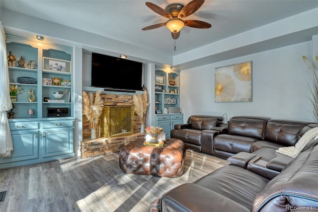 2770 Rossmere St, Colorado Springs, CO 80919 - living area with a stone fireplace, ceiling fan, wood finished floors, and built in shelves
