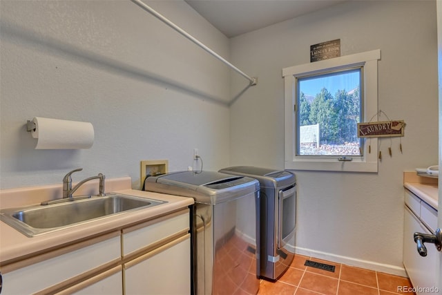 2770 Rossmere St, Colorado Springs, CO 80919 - laundry area featuring washer and clothes dryer, cabinet space, and light tile patterned floors