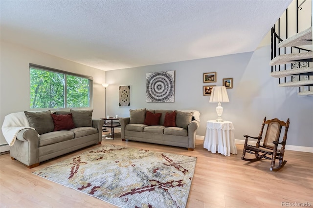 7020 E Girard Ave Unit 206, Denver, CO 80224 - living area featuring wood finished floors and a textured ceiling