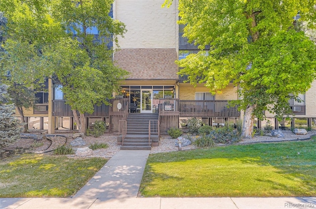 7020 E Girard Ave Unit 206, Denver, CO 80224 - view of front of home with a front yard, a shingled roof, and stairway