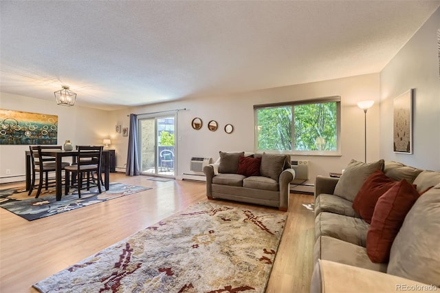 7020 E Girard Ave Unit 206, Denver, CO 80224 - living room with wood finished floors, baseboard heating, and a baseboard radiator