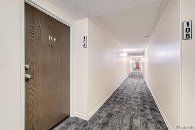 7020 E Girard Ave Unit 206, Denver, CO 80224 - corridor featuring dark colored carpet and baseboards