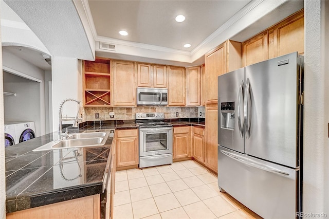 kitchen with kitchen peninsula, appliances with stainless steel finishes, crown molding, and sink